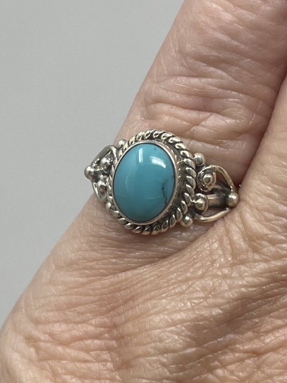 Sterling Silver Ring with Oval Turquoise Stone set in a decorative frame
